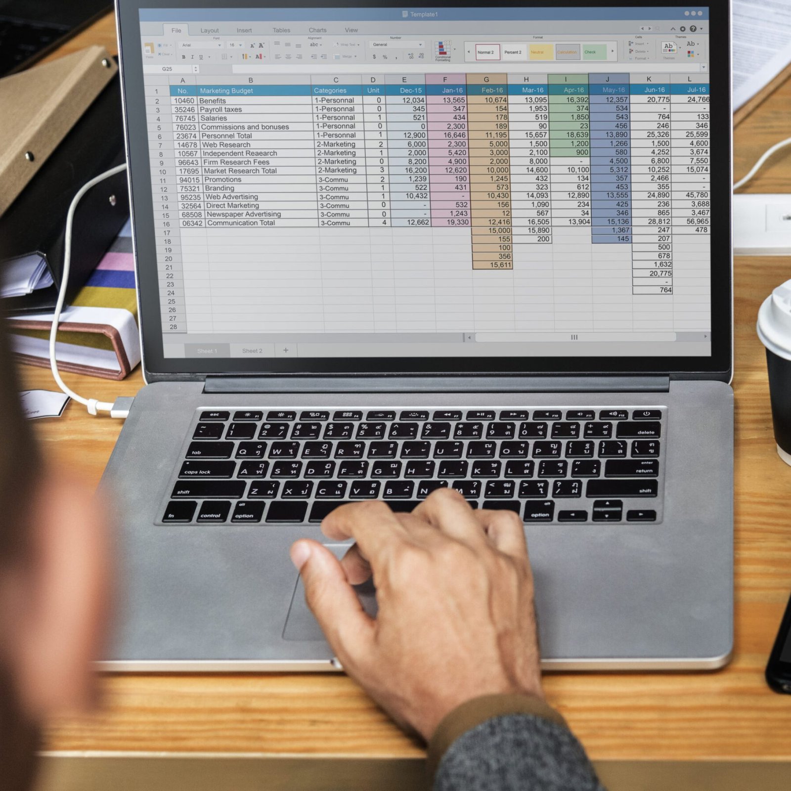 Businessman working a on laptop in a meeting